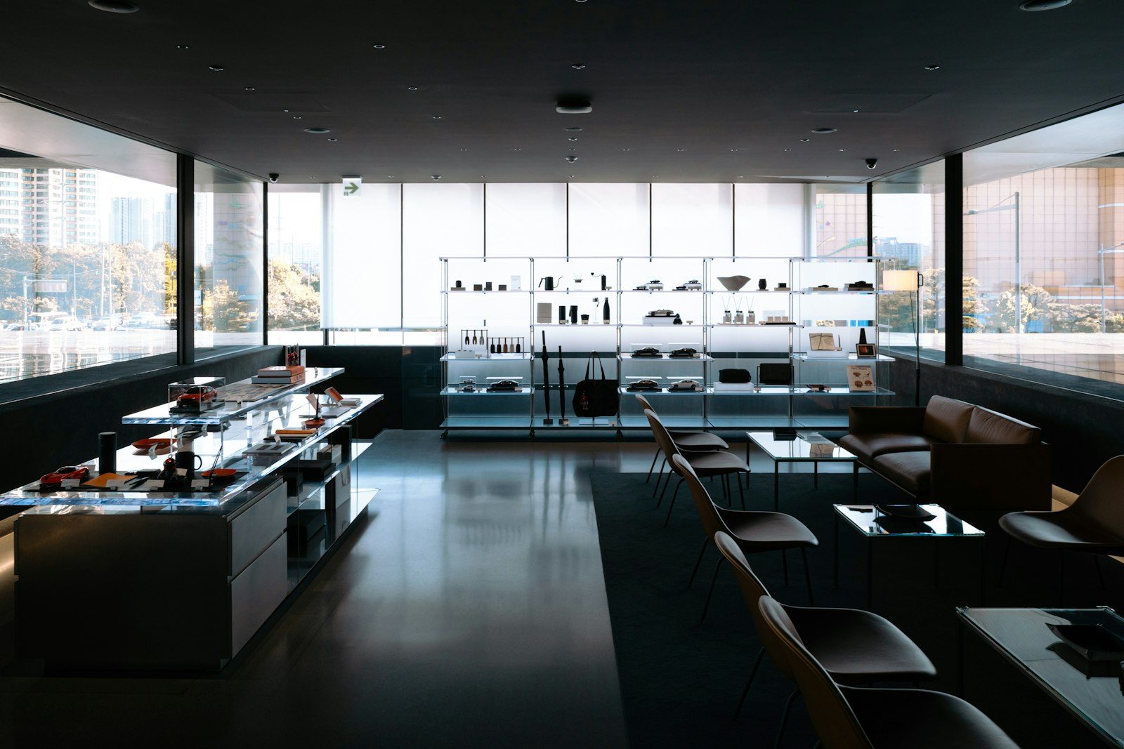 A luxury retail interior featuring brass fixtures, marble accents, and a solitary display bag.